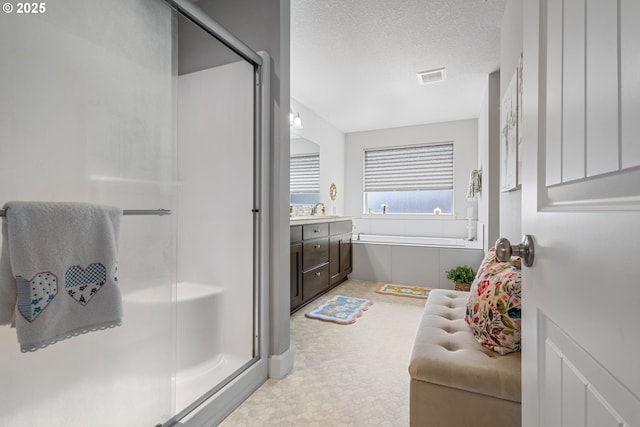 52152 Casswell Dr, Scappoose, OR 97056 - bathroom featuring a shower stall, a garden tub, vanity, and a textured ceiling