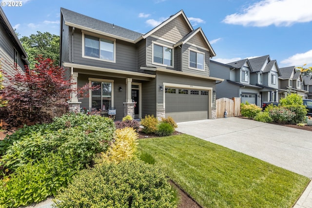 52152 Casswell Dr, Scappoose, OR 97056 - view of front facade with covered porch, driveway, an attached garage, a residential view, and stone siding