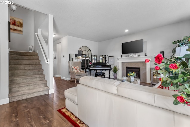 52152 Casswell Dr, Scappoose, OR 97056 - living area with stairs, dark wood-style flooring, a fireplace, and recessed lighting