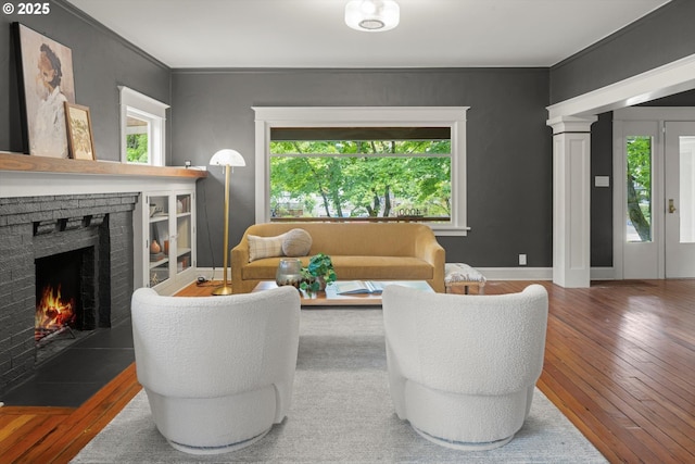 4000 NE Hassalo St, Portland, OR 97232 - living room featuring plenty of natural light, wood-type flooring, a brick fireplace, and ornamental molding