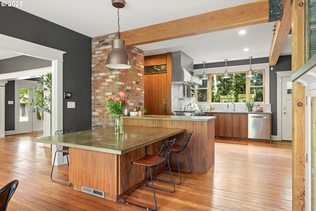 4000 NE Hassalo St, Portland, OR 97232 - kitchen featuring dishwasher, brown cabinetry, light wood finished floors, a breakfast bar, and beam ceiling