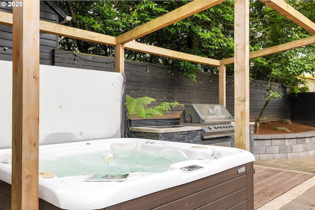 4000 NE Hassalo St, Portland, OR 97232 - fenced backyard with a hot tub, a grill, and a wooden deck