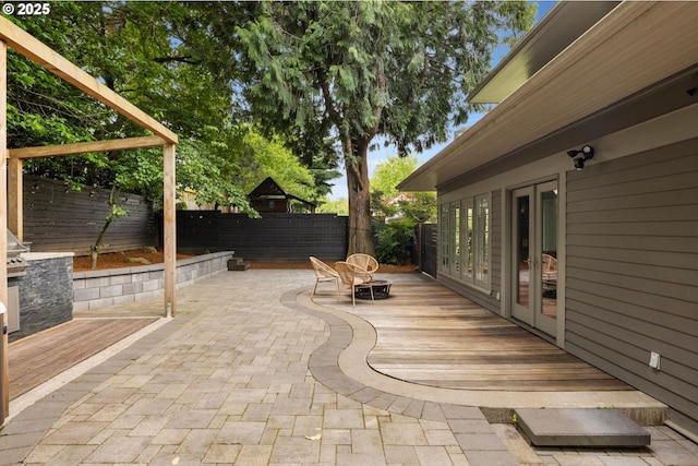 4000 NE Hassalo St, Portland, OR 97232 - fenced backyard with french doors, a deck, and a patio area