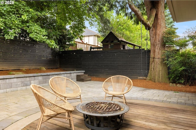 4000 NE Hassalo St, Portland, OR 97232 - wooden deck featuring a fenced backyard, a fire pit, and a patio area