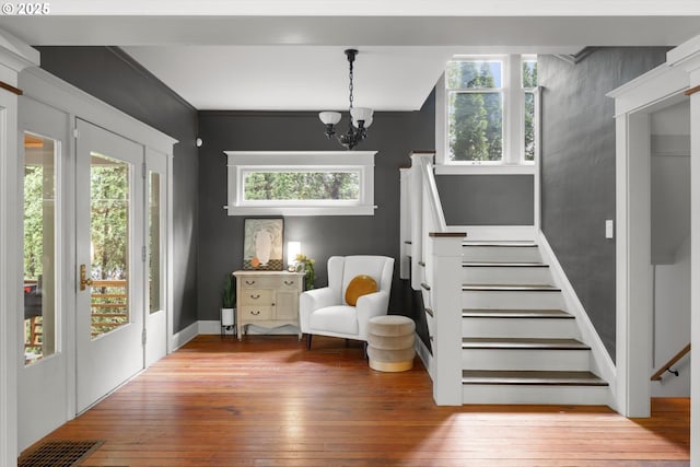 4000 NE Hassalo St, Portland, OR 97232 - foyer entrance featuring wood-type flooring, stairway, and a chandelier