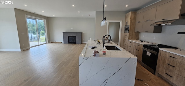 243 NE Hemmingway Dr, Stevenson, WA 98648 - kitchen with a sink, black stove, modern cabinets, open floor plan, and recessed lighting