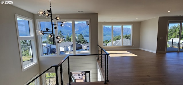 243 NE Hemmingway Dr, Stevenson, WA 98648 - unfurnished dining area featuring a chandelier, dark wood-style flooring, baseboards, recessed lighting, and a mountain view