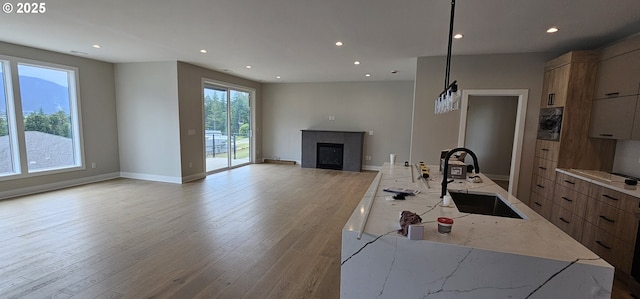 243 NE Hemmingway Dr, Stevenson, WA 98648 - kitchen featuring a sink, modern cabinets, a fireplace, recessed lighting, and open floor plan