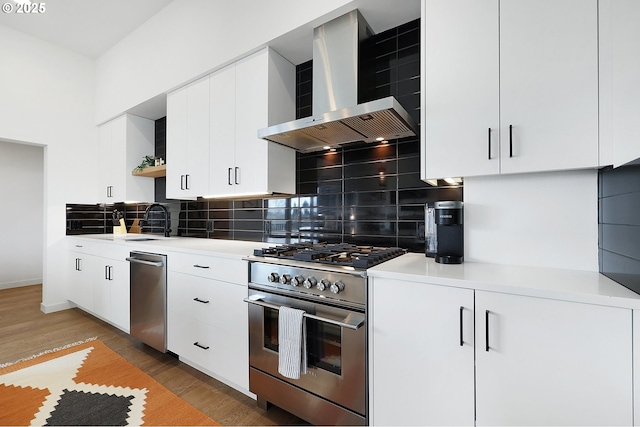 kitchen with backsplash, white cabinets, wall chimney exhaust hood, dark hardwood / wood-style floors, and stainless steel appliances