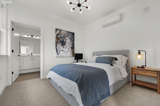 bedroom with a notable chandelier, light colored carpet, an AC wall unit, and connected bathroom