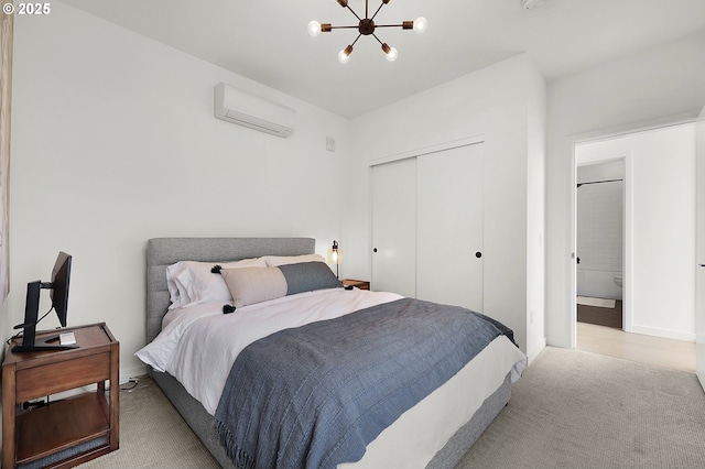 bedroom featuring a closet, a wall mounted AC, a notable chandelier, and light colored carpet