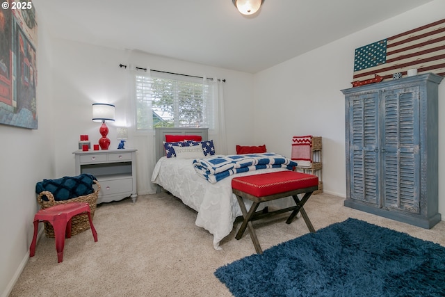 carpeted bedroom featuring baseboards