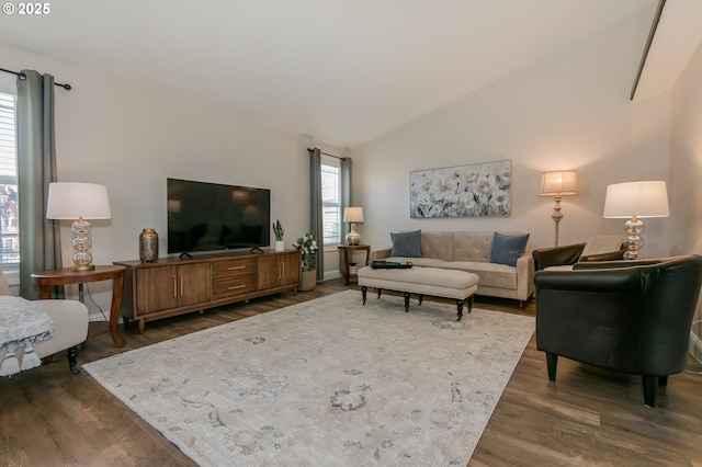 living area featuring vaulted ceiling and dark wood-type flooring