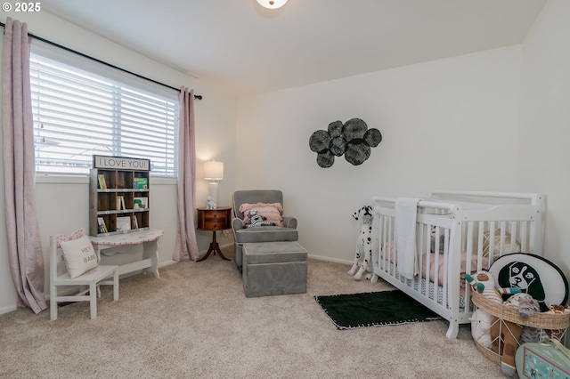 carpeted bedroom with a nursery area and baseboards