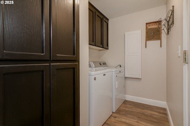 laundry area with cabinet space, separate washer and dryer, baseboards, and light wood-style flooring