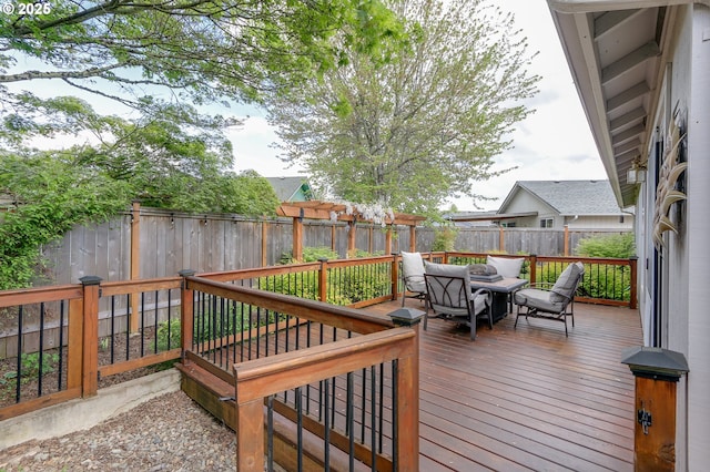 wooden terrace featuring a fenced backyard