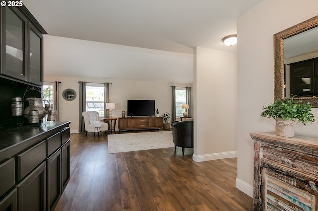 living area with baseboards and dark wood-style floors