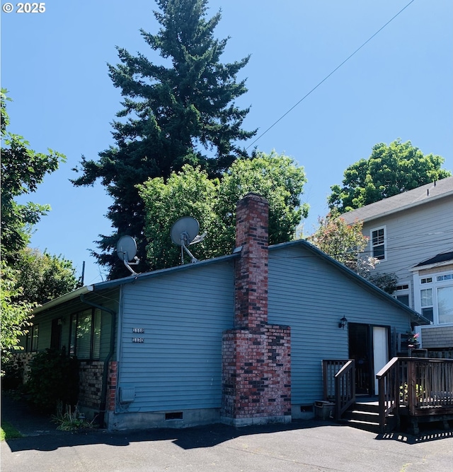 11181120 SE 45th Ave, Portland, OR 97215 - view of home's exterior with a wooden deck and a chimney