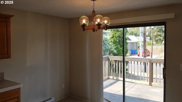 11181120 SE 45th Ave, Portland, OR 97215 - unfurnished dining area featuring a chandelier, a textured ceiling, and a baseboard radiator