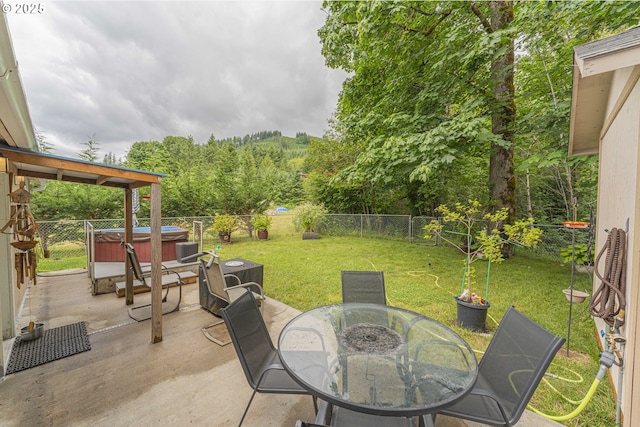 217 Mulkey Ln, Ariel, WA 98603 - fenced backyard featuring a hot tub, a patio, outdoor dining area, and a forest view