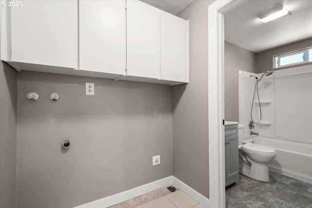laundry room with baseboards
