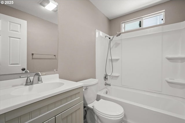 bathroom featuring toilet, vanity, and shower / bathtub combination