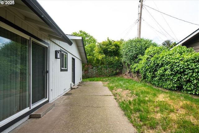 view of yard featuring fence and a patio