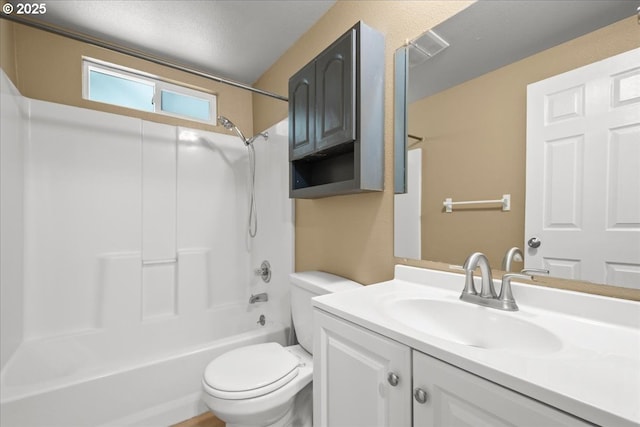full bath featuring toilet, vanity, bathtub / shower combination, and a textured ceiling