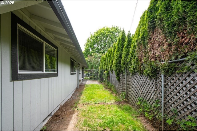 view of side of home featuring a fenced backyard