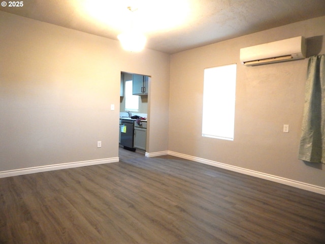 unfurnished living room with dark hardwood / wood-style floors and an AC wall unit