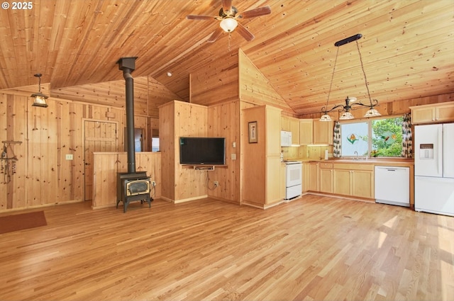 10268 Field Crest Dr, Birkenfeld, OR 97016 - kitchen with white appliances, lofted ceiling, wooden walls, a wood stove, and light wood finished floors