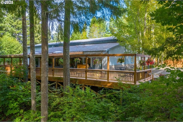 rear view of property featuring a wooden deck