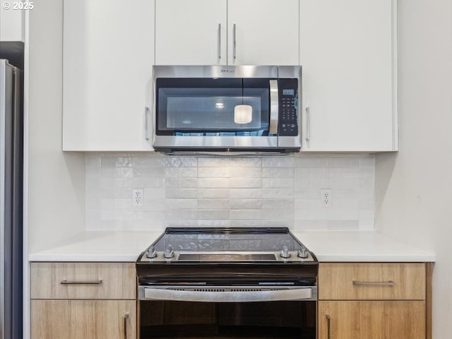 kitchen with white cabinetry and stainless steel appliances