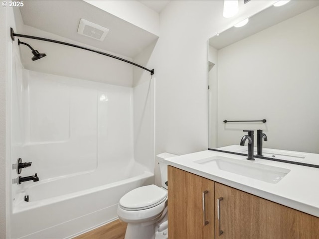 full bathroom featuring washtub / shower combination, vanity, toilet, and hardwood / wood-style floors