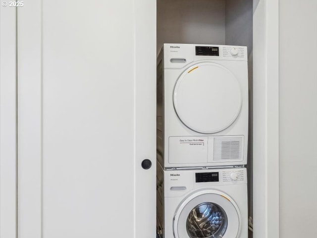 laundry room with stacked washer / dryer