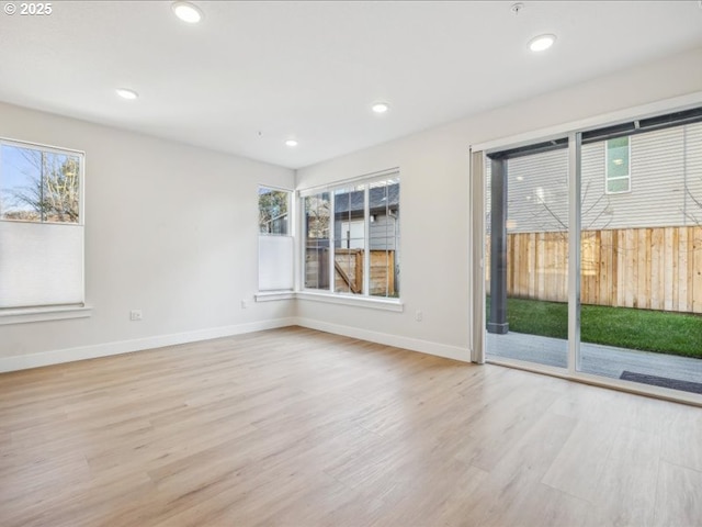 empty room with light hardwood / wood-style flooring