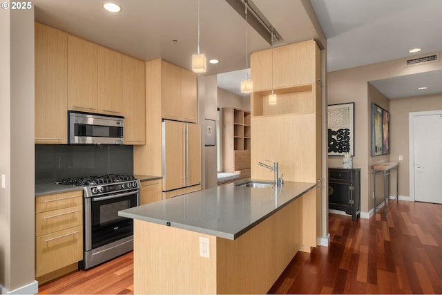 kitchen featuring stainless steel appliances, light brown cabinets, a sink, dark wood-style flooring, and recessed lighting