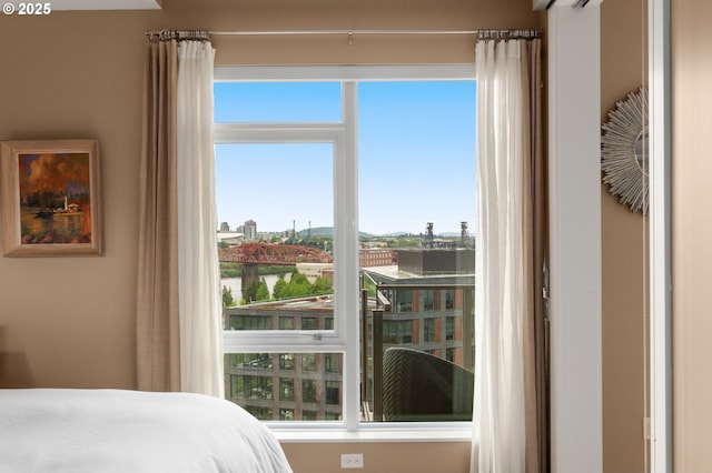 bedroom with multiple windows and a water view