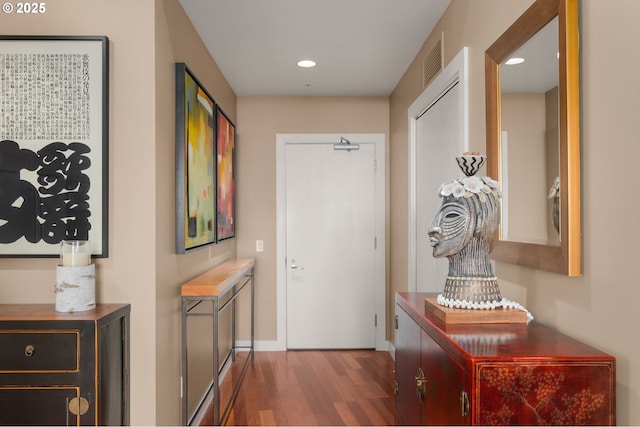 doorway to outside featuring wood finished floors, baseboards, and recessed lighting