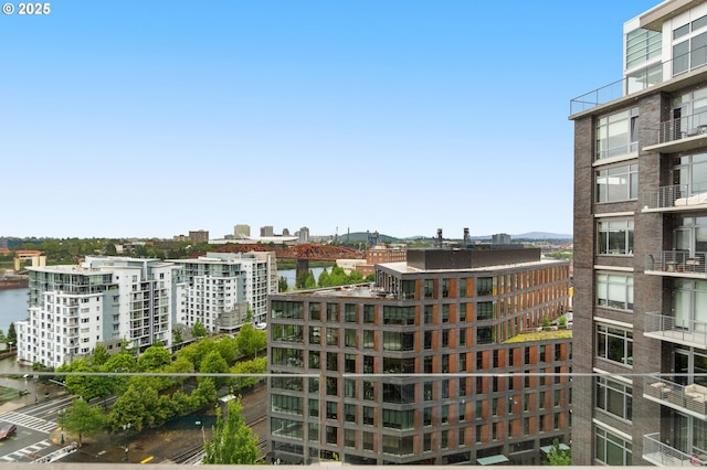 view of property with a water view and a view of city