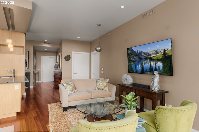 living area with dark wood finished floors, recessed lighting, and baseboards