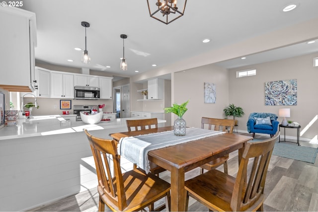 313 Art Kegler Blvd, Boardman, OR 97818 - dining area featuring light wood-type flooring, recessed lighting, a chandelier, and baseboards