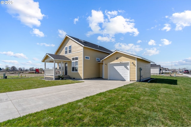 313 Art Kegler Blvd, Boardman, OR 97818 - view of side of property with concrete driveway, a lawn, a porch, and a garage