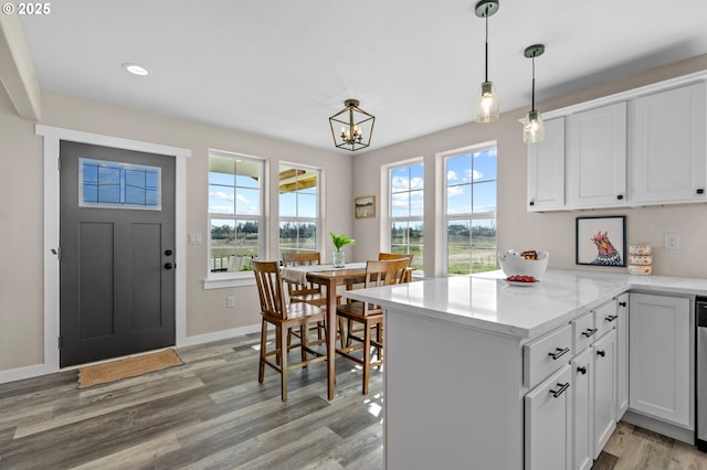313 Art Kegler Blvd, Boardman, OR 97818 - kitchen featuring a peninsula, light wood-style floors, white cabinetry, decorative light fixtures, and recessed lighting