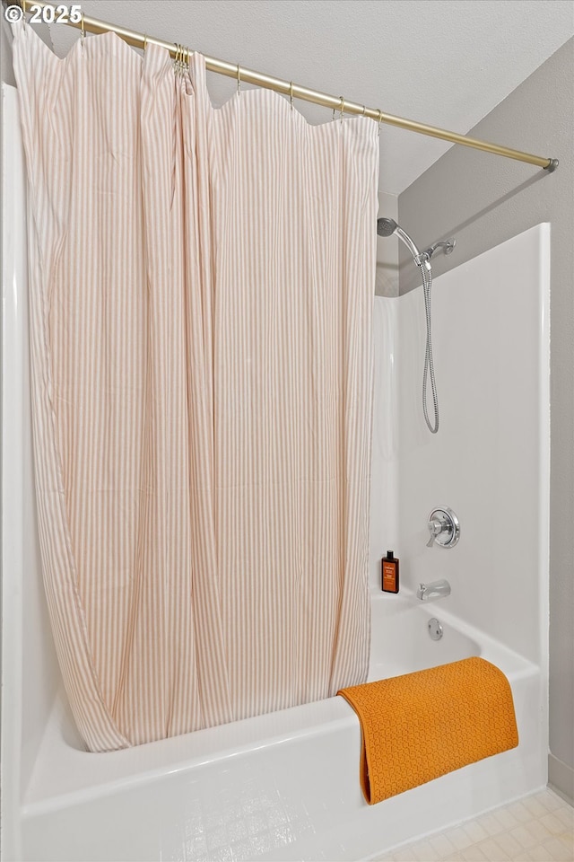 bathroom with shower / bathtub combination with curtain