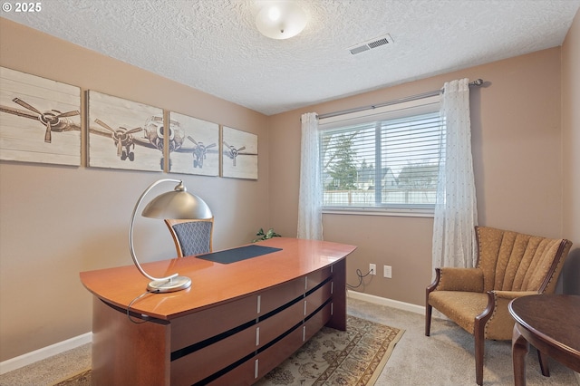 office space with light colored carpet and a textured ceiling