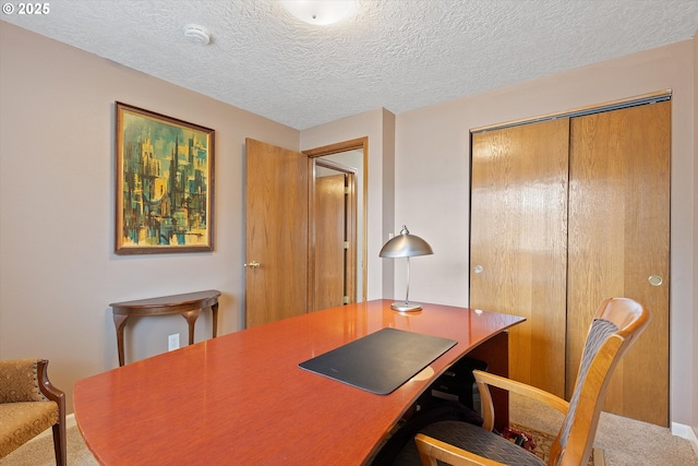 office area with a textured ceiling