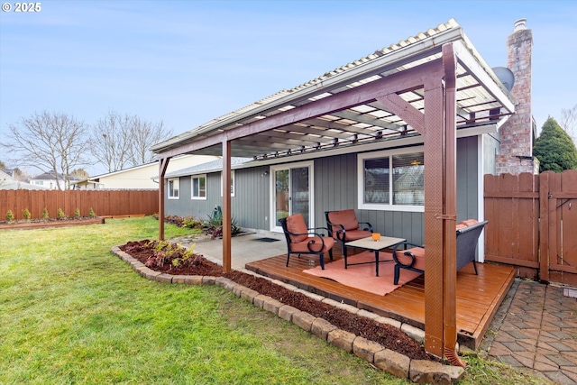 back of property with a wooden deck, a yard, and a pergola