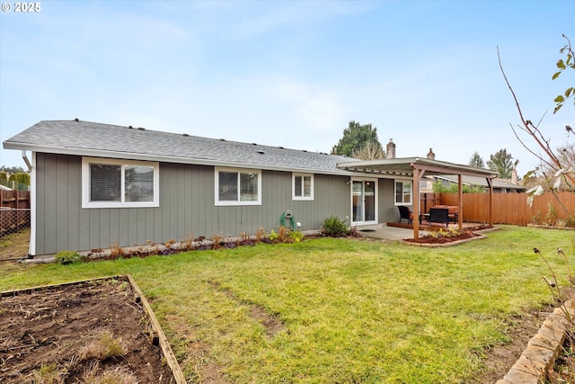 rear view of property with a lawn and a patio