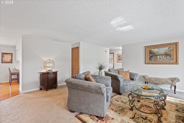 living room with light colored carpet and a textured ceiling